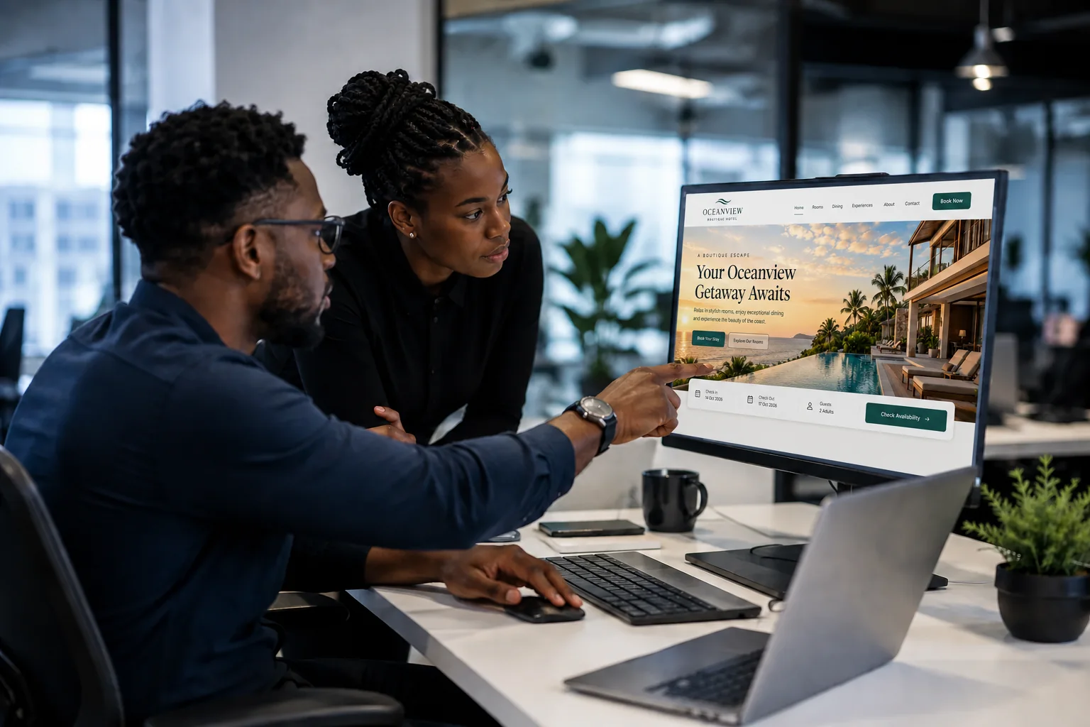 Black technology professionals collaborating on a website design in a modern office